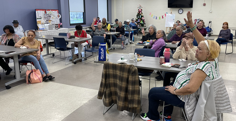 Participants raise hands in classroom setting