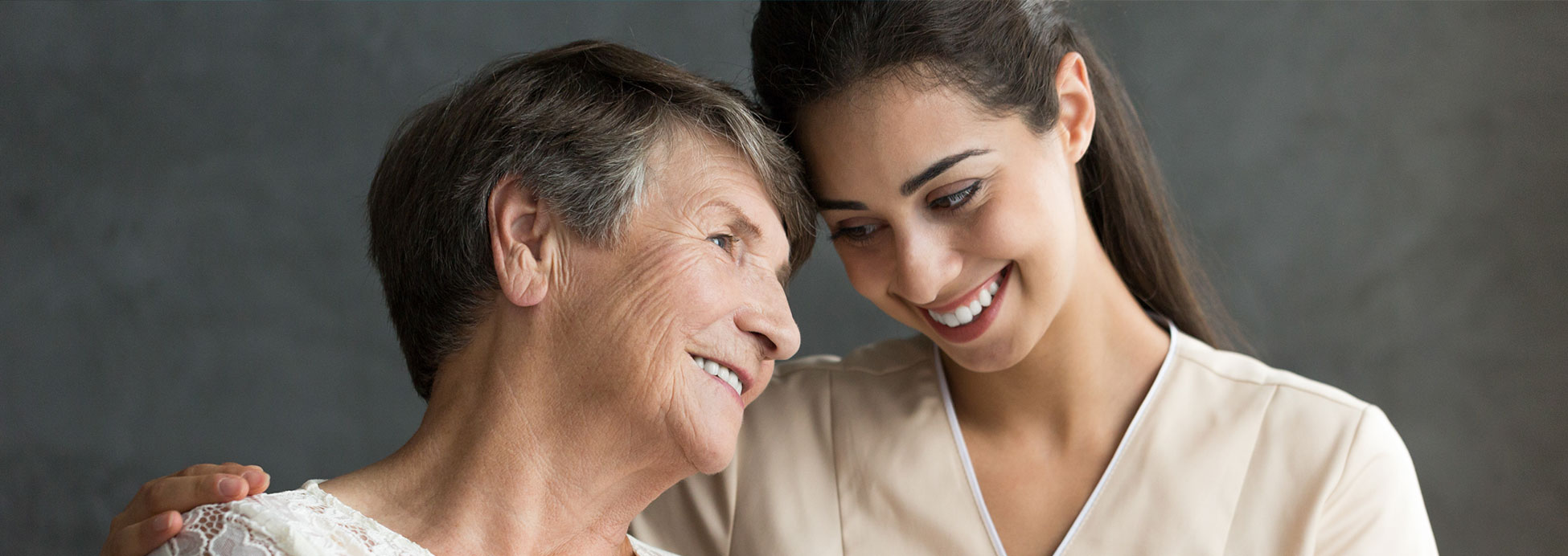 Elderly woman and caregiver