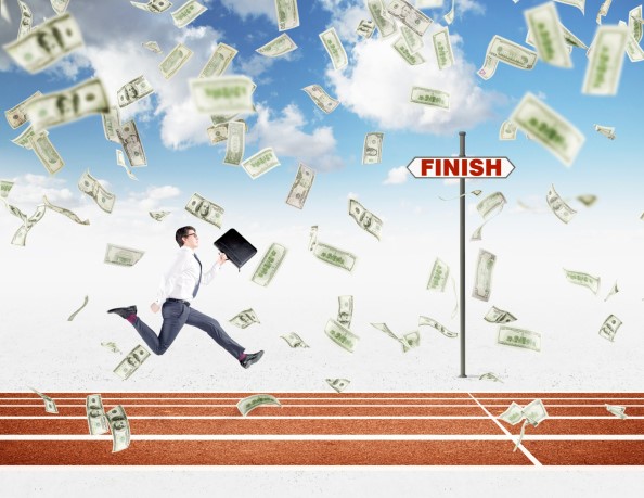 Businessman running on track, money falling from sky