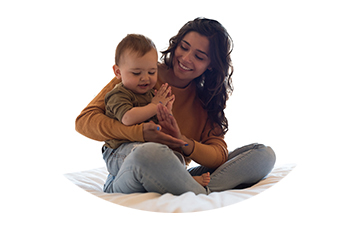 Latin mother sitting with her son on a bed