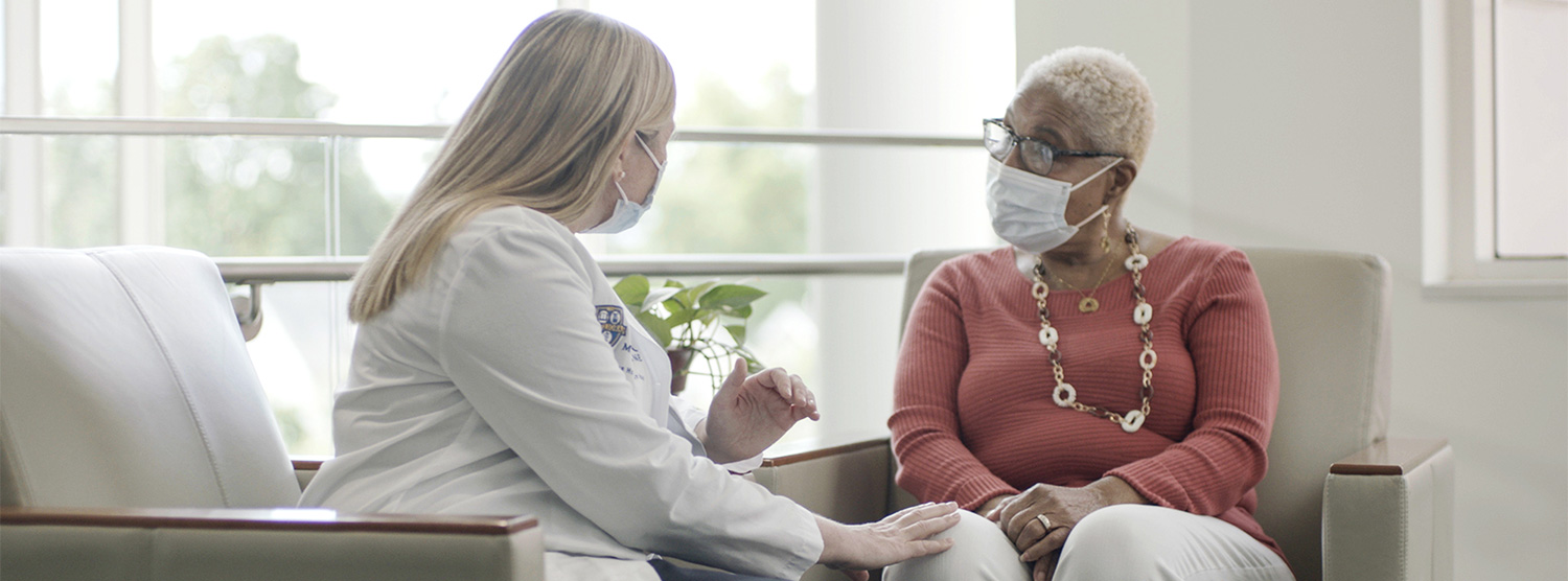 Dr. Anna Weiss Sitting and Talking With Patient