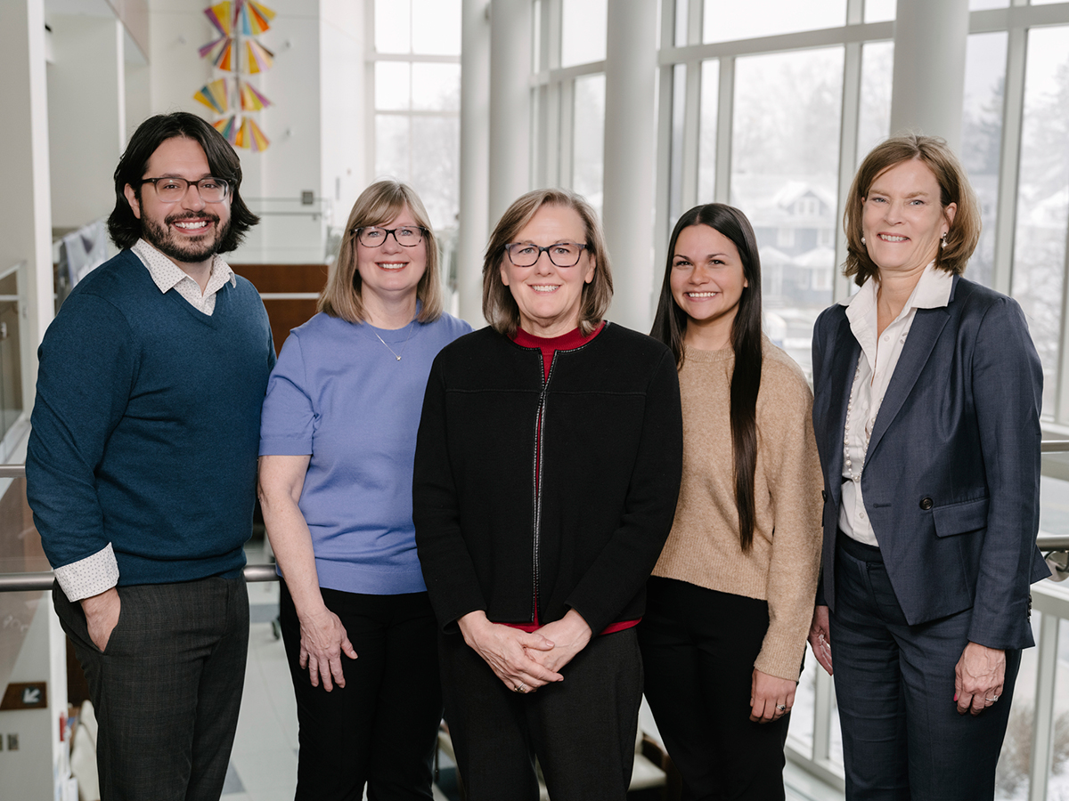 A group photo of the Wilmot Cancer Institute survivorship team, smiling and standing together in a bright office setting.