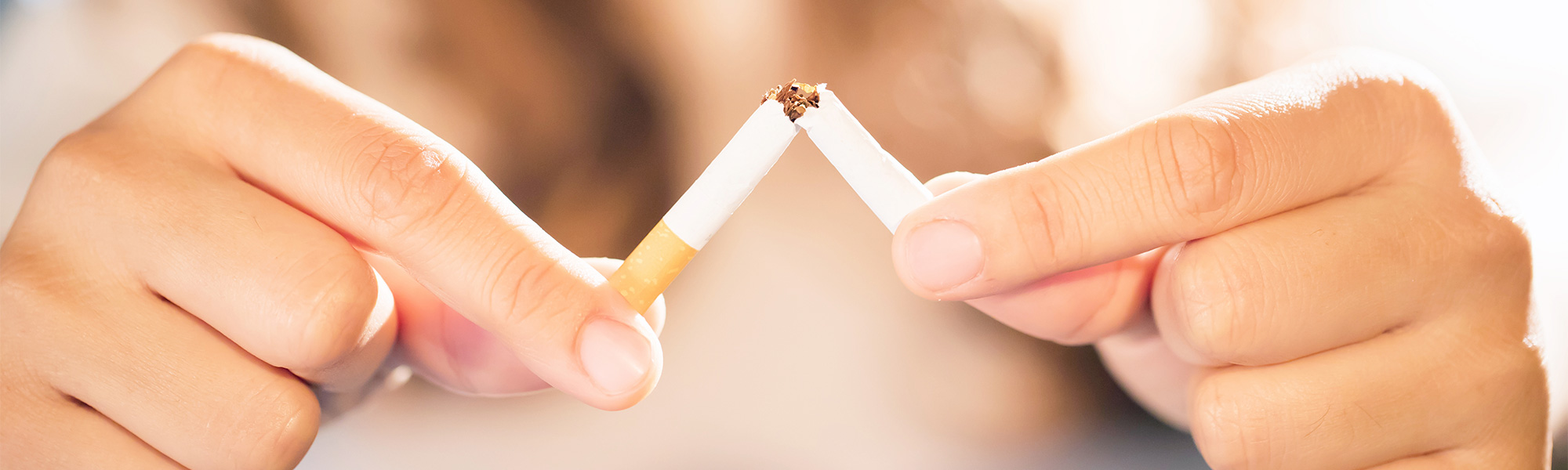 Woman Breaking a Cigarette in Half