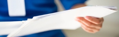 Health care professional holding documents