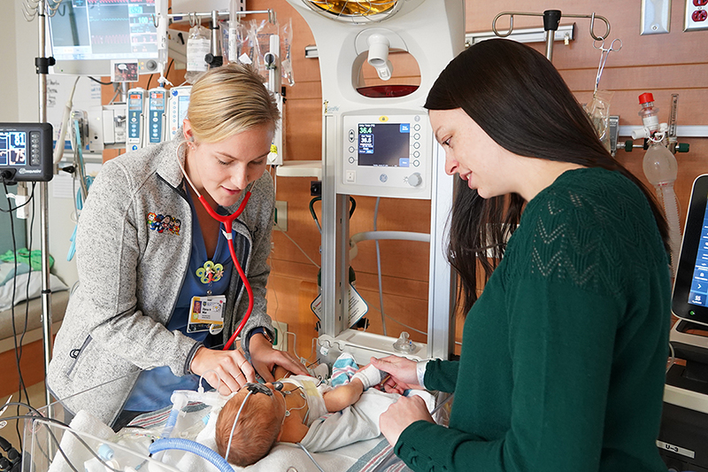 Baby with Mom and a provider