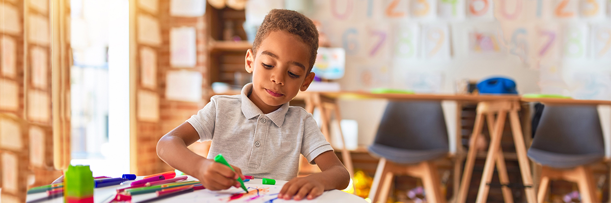 Boy drawing with art supplies