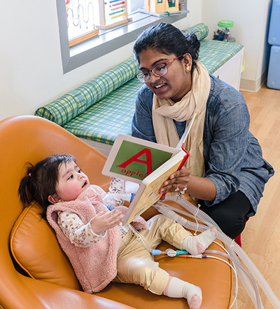 Eliyah reading with Mom.