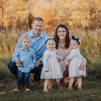 Csapo triplets in a field with their parents