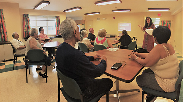 People at tables listening to presentatioin