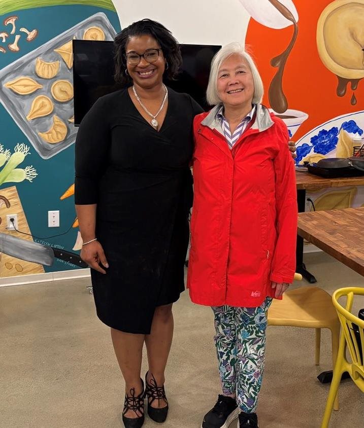Two women standing together smiling at camera