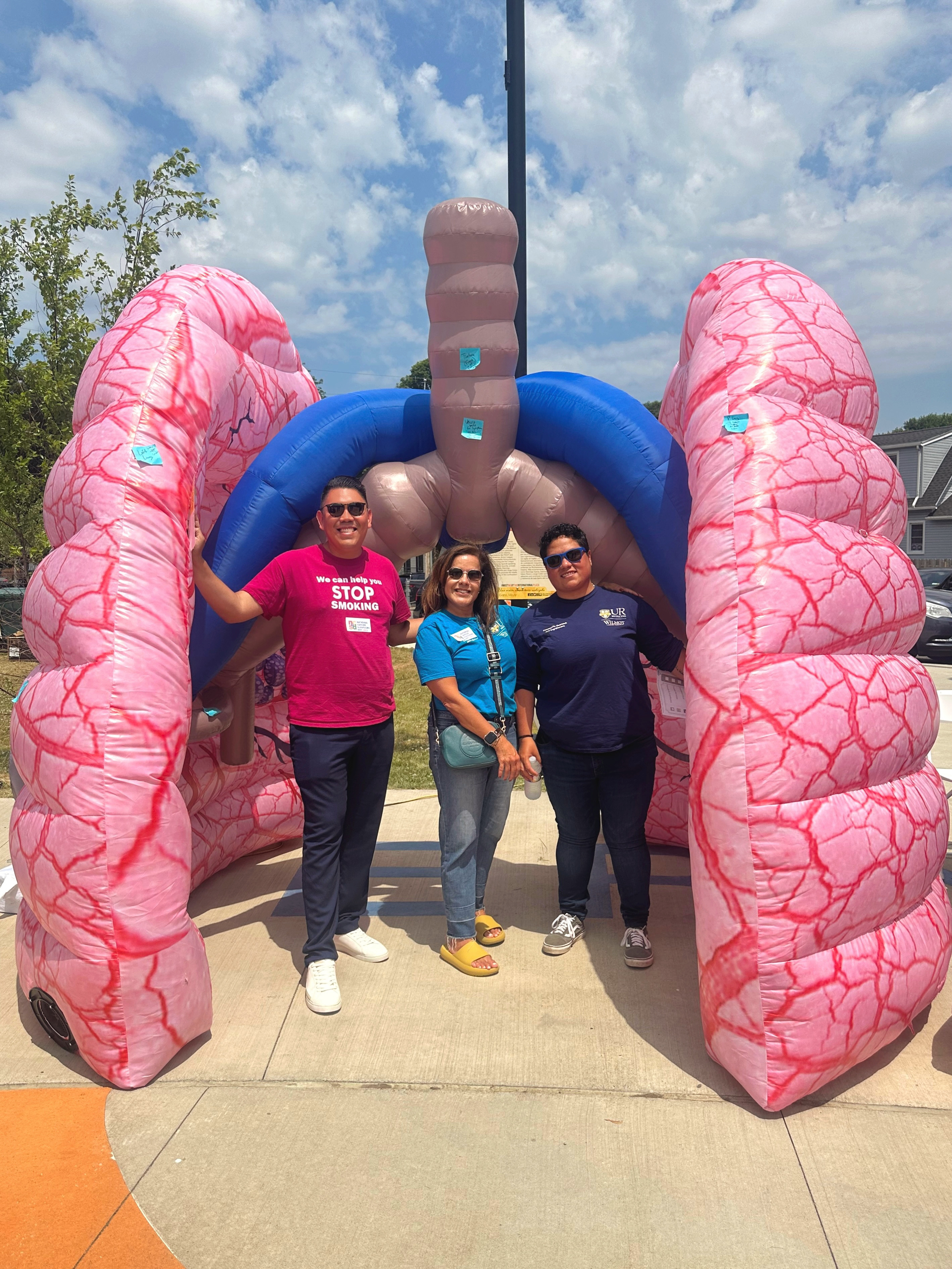 outreach team stands in front of inflated lungs