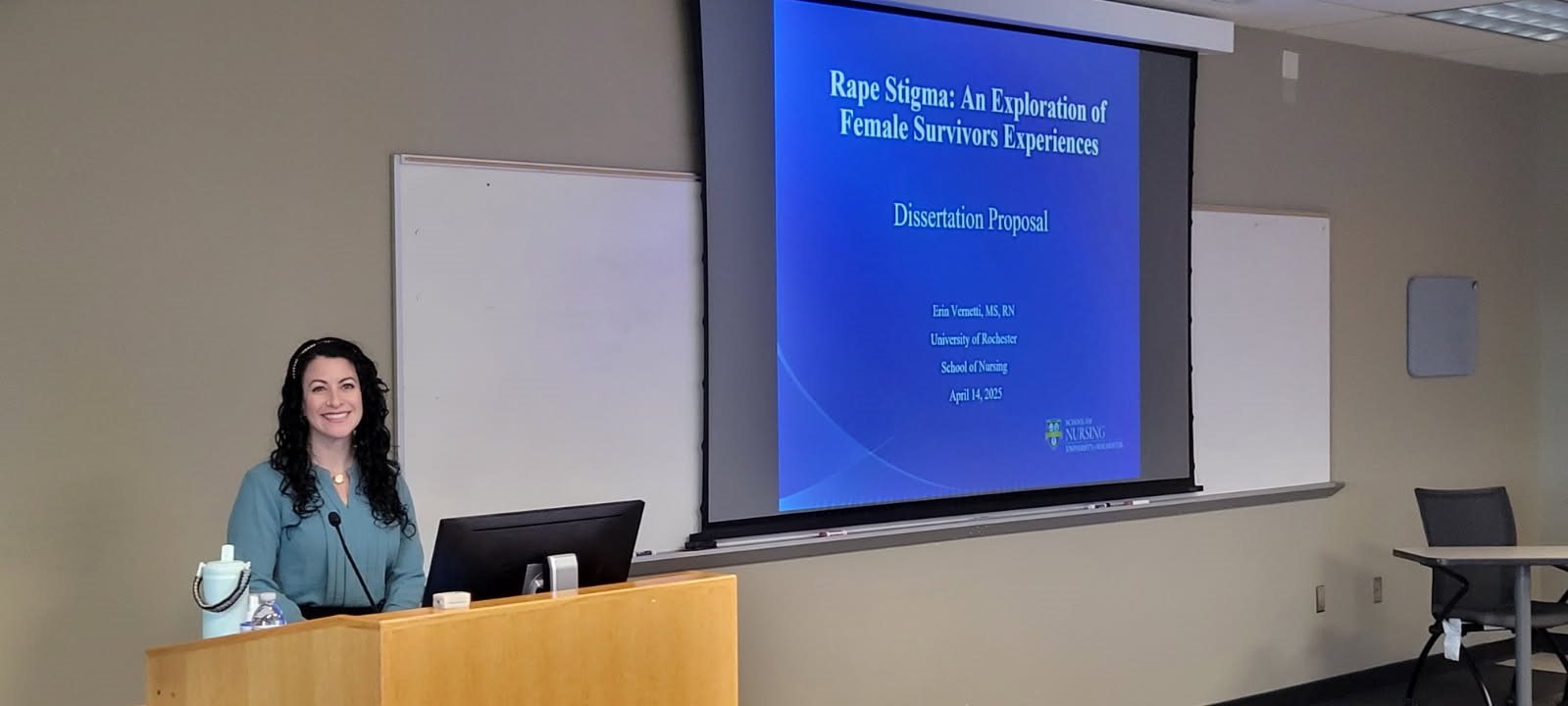 person in front of podium with presentation