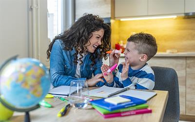 Photo of researcher with a child playing