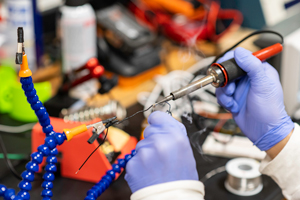 student using soldering iron