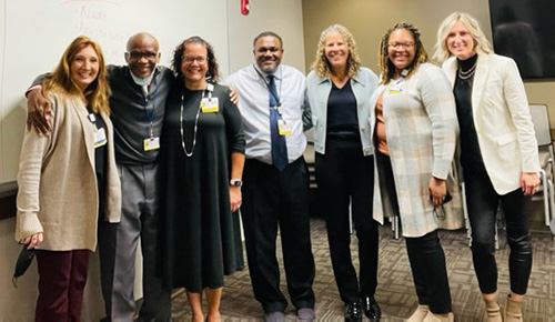 Group of faculty with Rochester Commissioner Chinazo Cunningham