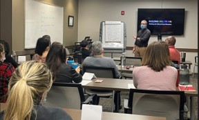 students in classroom watching instructor