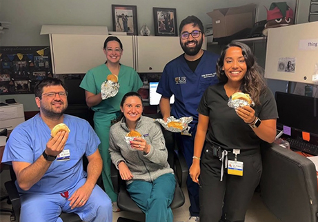 Fellows eating breakfast sandwiches together