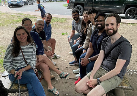 Fellows hanging out together outside on benches