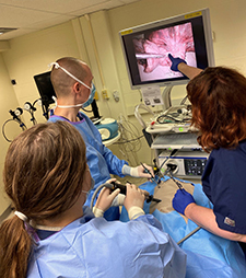 Chief of Thoracic and Foregut Surgery, Dr. Jones, with PGY1 Ariana Goodman and PGY2 Nick Searcy during a Lobectomy simulation lab