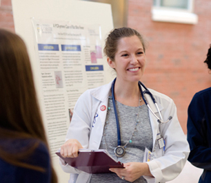 Resident presenting poster to group