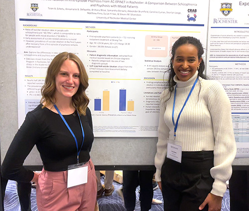 two residents at a poster session