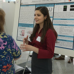 Alejandra Lorenzen with poster