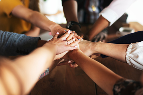 people joining hands together