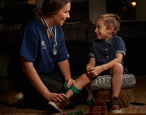 Home Care nurse helping child patient