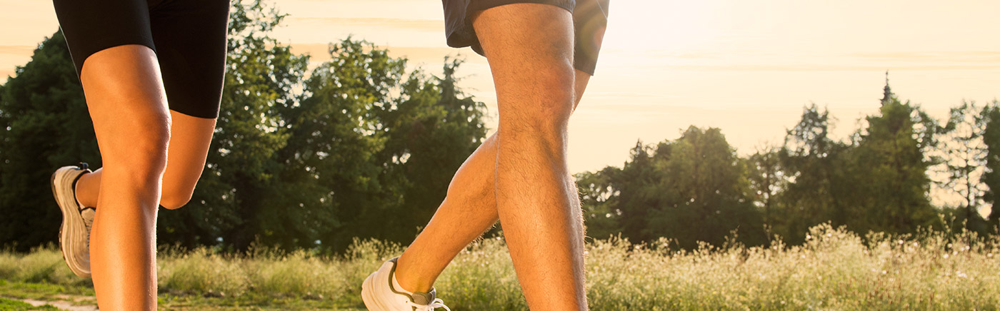 Legs of a man and woman running