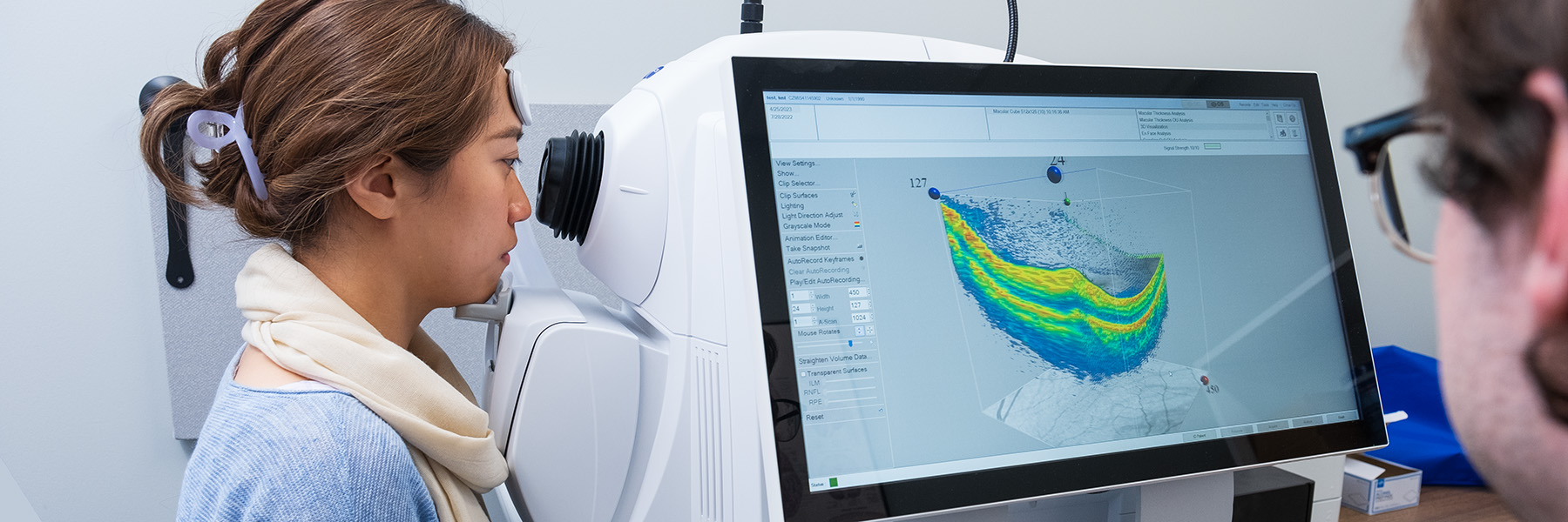 Woman scanning eye in machine