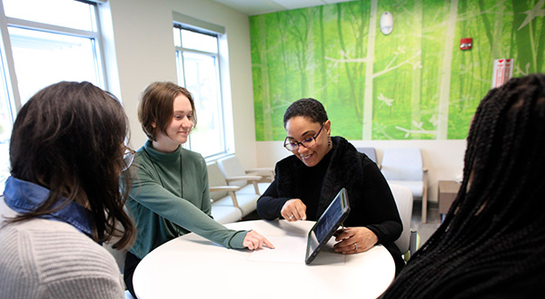 Arielle Sheftall and lab researchers using ipad