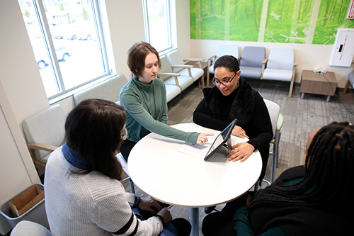 Arielle Sheftall and lab researchers looking at ipad