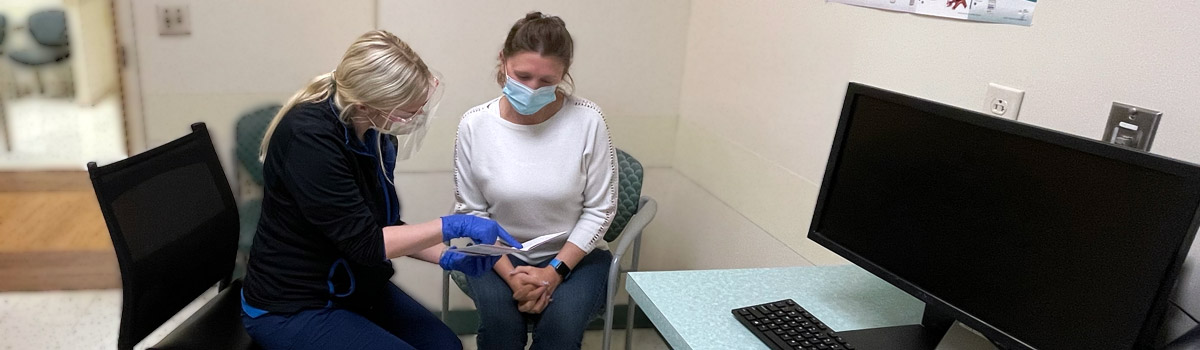 One of our nurses reviewing care notes with patient