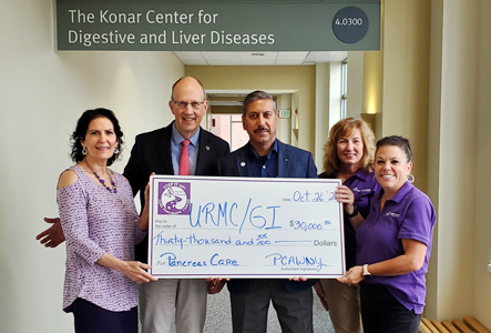 Mary Pettinaro, Lynn Platt and Mary Ellen Smith present check to Mark Levstik, MD and Vivek Kaul, MD