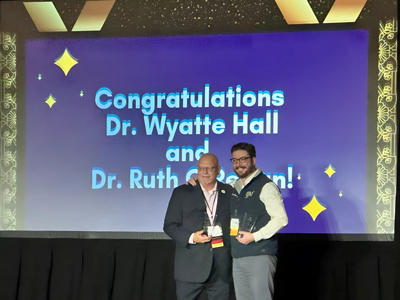 Hall (right) and McLetchie (left) accepted the award at the CEASD meeting in Pittsburgh on behalf of O’Regan and the entire Wilmot Future Deaf Scientists team
