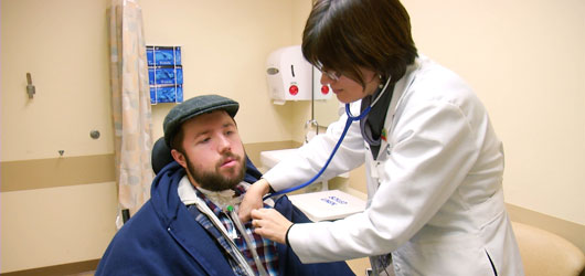 doctor listening to patient's heart