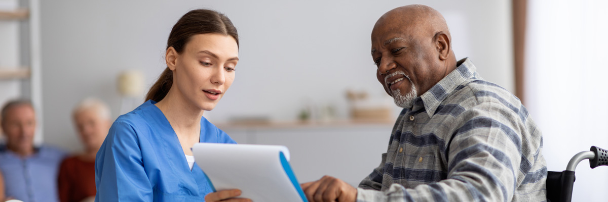 Woman medical person talking with older man