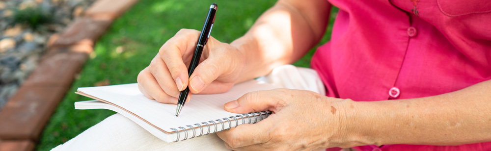 older woman writing a note