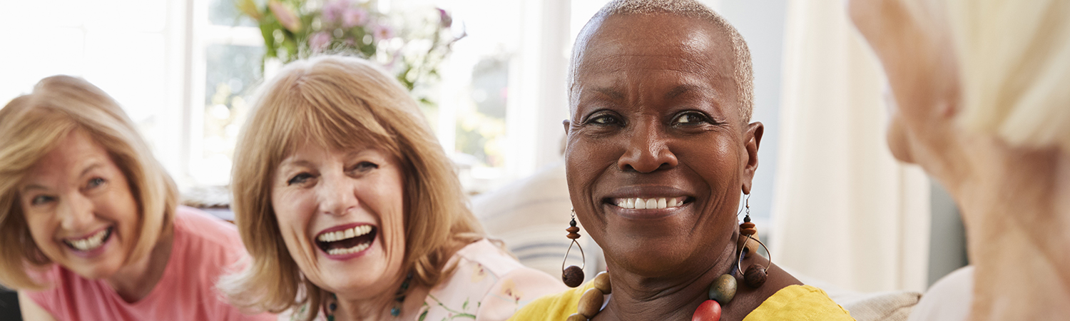 Group of 4 women laughing on the couch