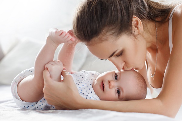 Mother kissing newborn