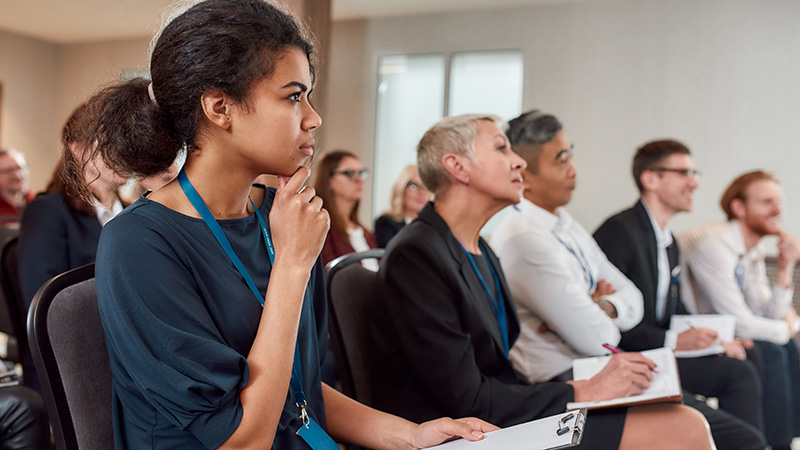 Group of people listening to a speaker