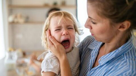 Woman comforting young child