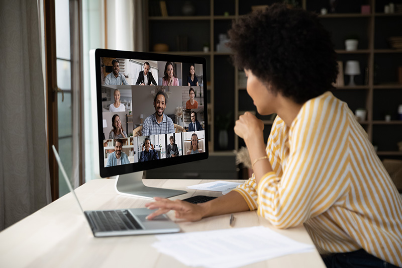 women looking at computer screen with Zoom meeting