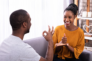 Two people using sign language to communicate