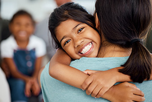 child hugging her mother