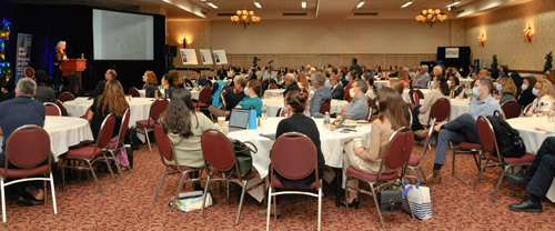 large conference room with people sitting at tables