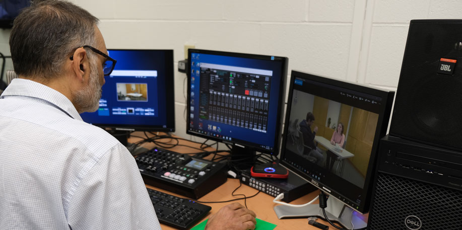 Steve Fasone editing video on a computer