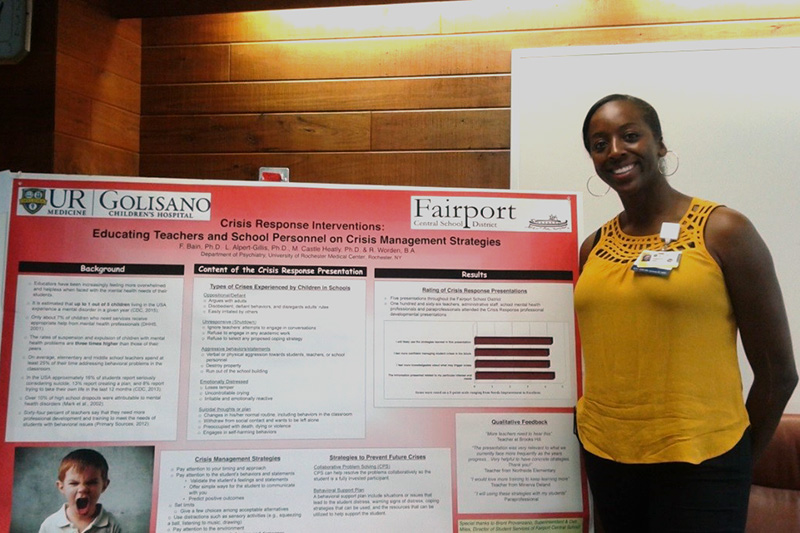 graduate student presenting poster