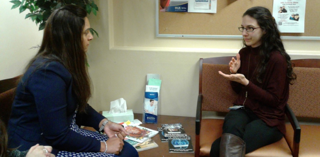 two women using sign language in a conversation