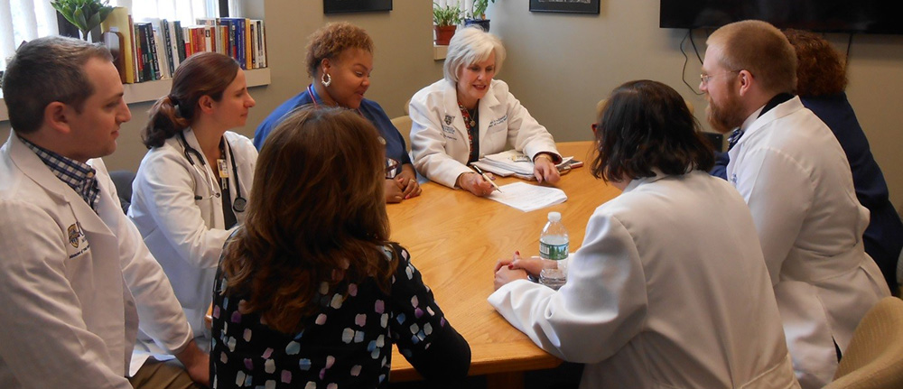 Group of faculty talking at table